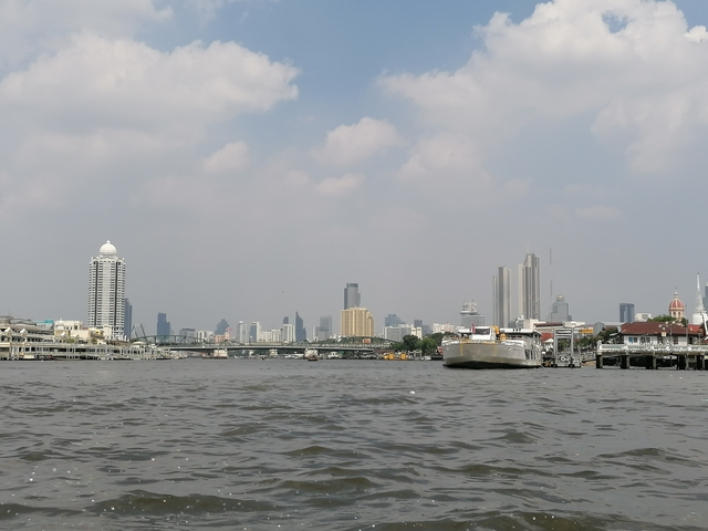 Skyline view of a city across a river.