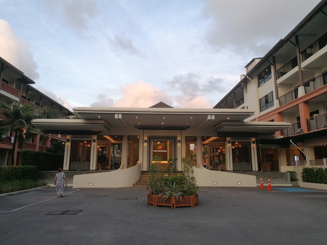 Hotel entrance with people outside.