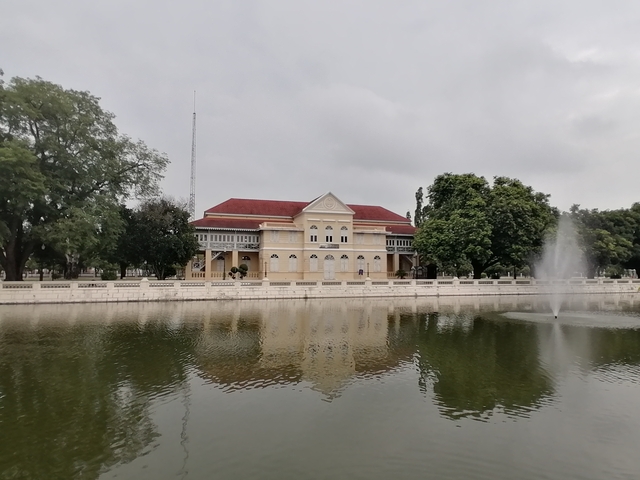 Historic building by a reflective pond.