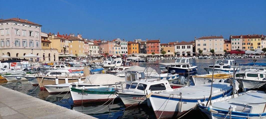 Harbor with docked boats and colorful buildings.
