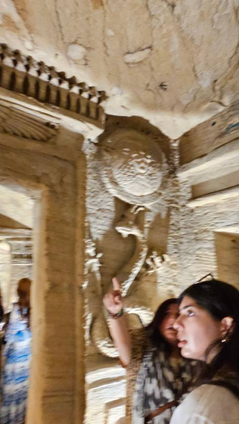 Blurred image of two people exploring ancient ruins.