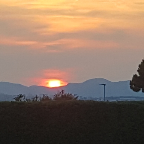 Blurry image of a sunset over mountains.