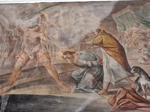 Detailed religious frescoes on a wall