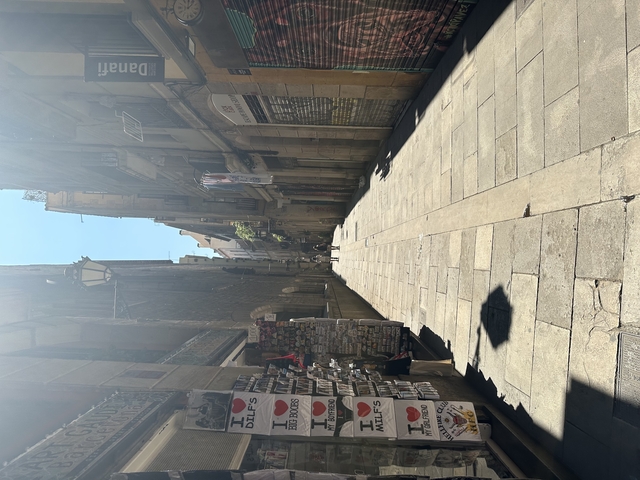 A narrow pedestrian street with vintage shops.