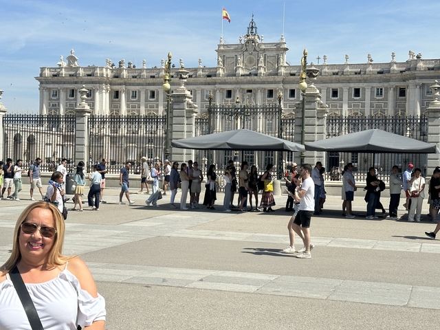 People standing outside a royal palace.