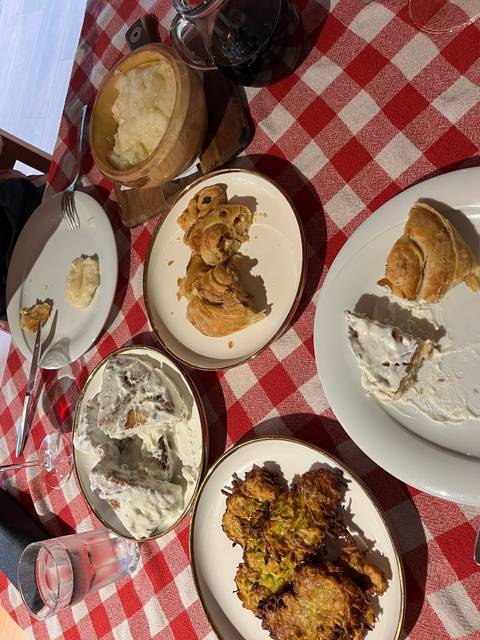 Table with a variety of dishes on a checkered tablecloth.