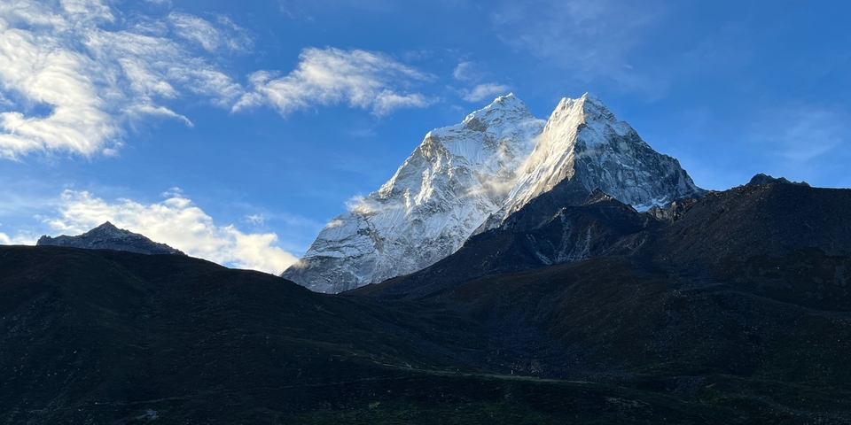 Snow-capped mountain peak under a blue sky.