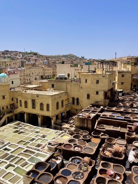 Tannery with vats used for dyeing leather, set in a historic city.