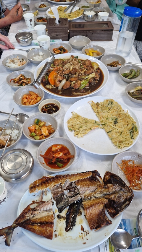 Plates of Korean dishes including pancakes and sides.