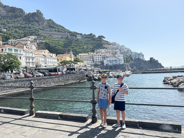 Two boys posing with the Amalfi coast in the background.