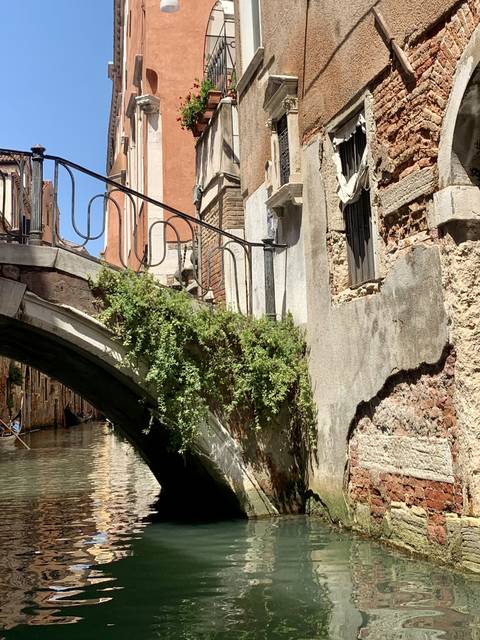 Picturesque view of a stone bridge over a canal lined with buildings.