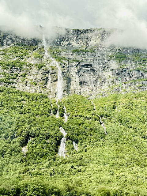 Beautiful waterfall surrounded by lush greenery.