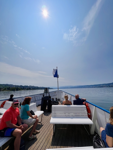 People on a boat enjoying a sunny day on the lake.