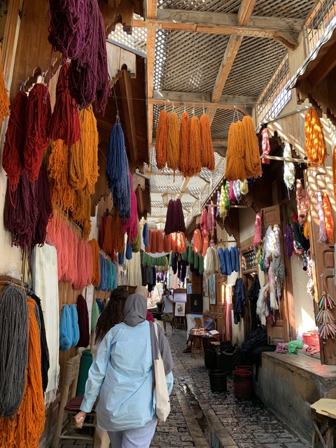Colorful yarns hanging inside a traditional market.