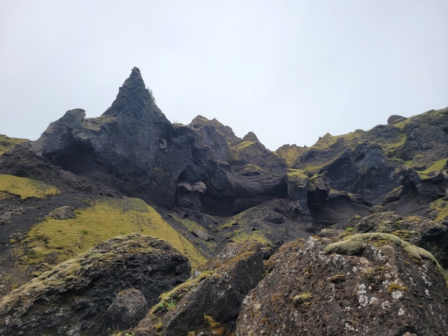 Scenic view of rugged volcanic terrain with green moss.