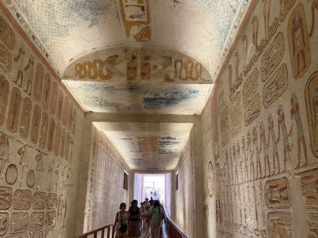 Interior of a tomb with detailed ancient carvings.