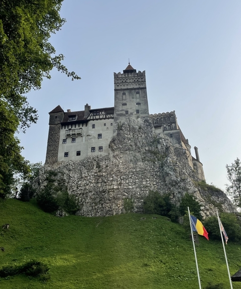 Bran Castle perched on a rocky hill with a dramatic facade.