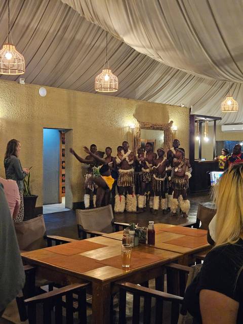 Indoor performance with people in traditional attire.