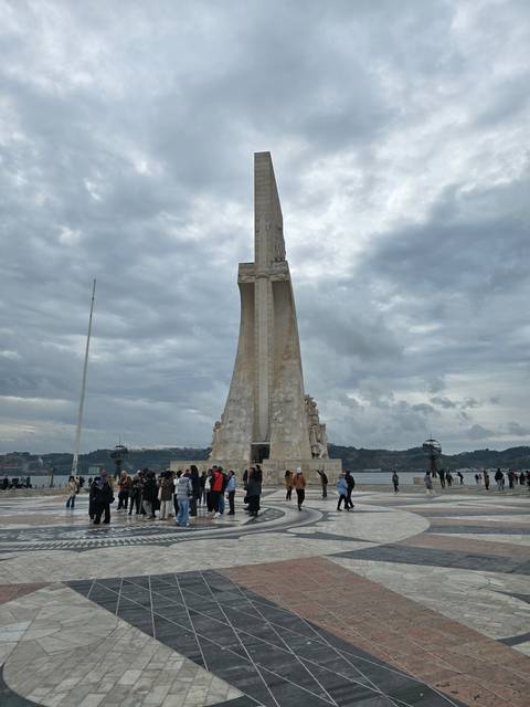 A monument with people gathered around it.