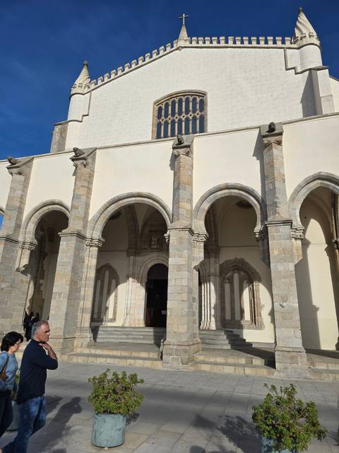 A white church with arches and columns.