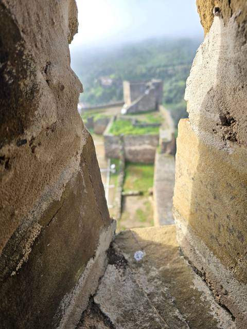 View through a stone opening to a landscape.