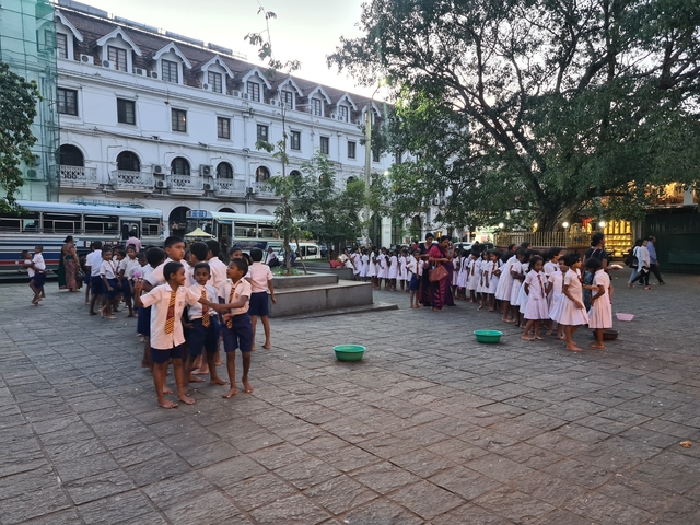 Children gathered outside a school building.