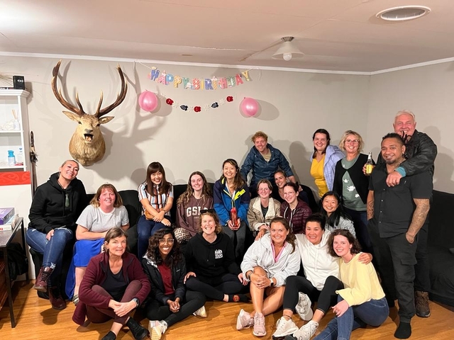 Group of people celebrating a birthday indoors.