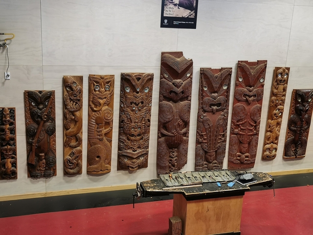Collection of intricately carved Maori wooden panels.
