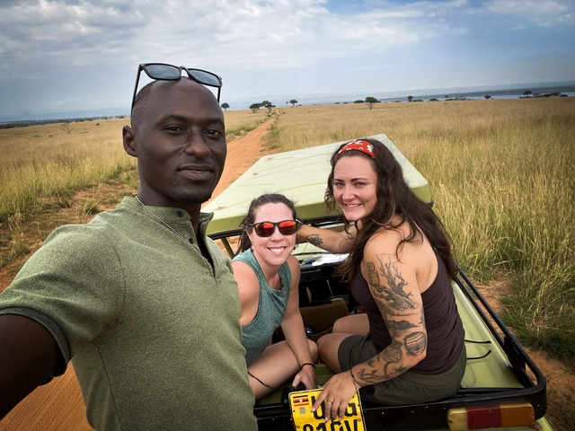 Group of people on a safari vehicle in a savannah