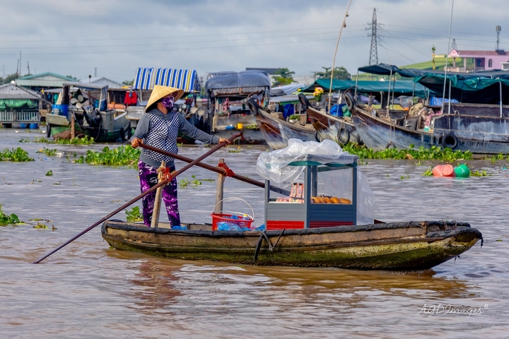 Vendor on a boat at a floating market.