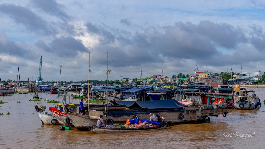 Boats on a river crowded with items and people.