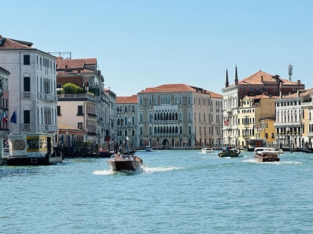 Venetian canal with boats and historic buildings.