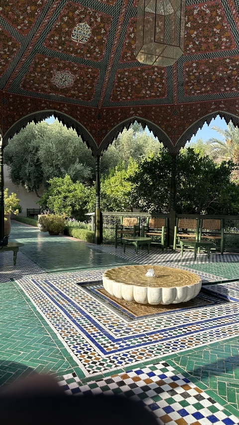 Peaceful garden with tiled patterns and seating area.