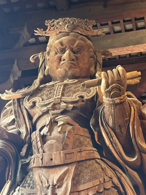 Close-up of an intricately carved wooden statue.
