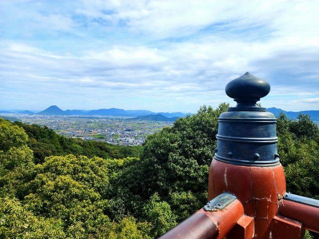 Scenic view of landscape with distant mountains and trees.