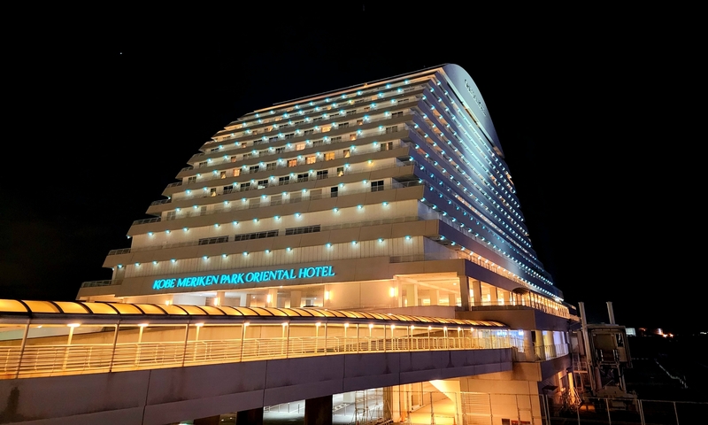 Modern hotel building illuminated at night.