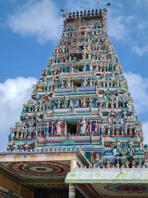 Colorful temple tower adorned with intricate statues.