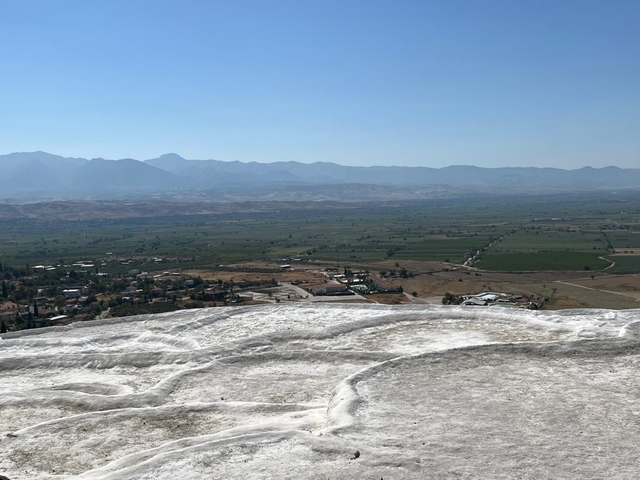 Distant view of a flat landscape with rolling hills.