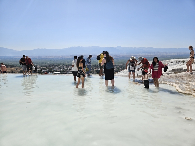 Visitors enjoying a pool with scenic views.