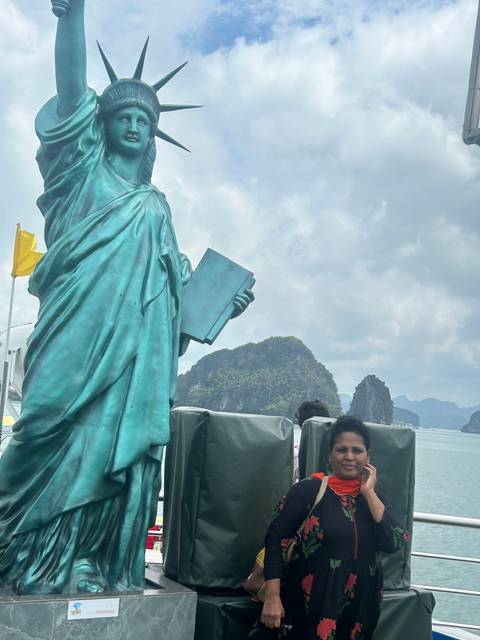 Upside-down image of a person beside a replica of the Statue of Liberty.