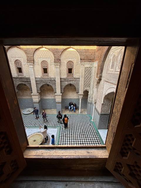 View of a historic courtyard with intricate tile patterns.