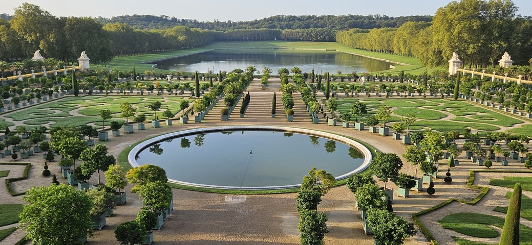 Ornate garden with fountain and lake