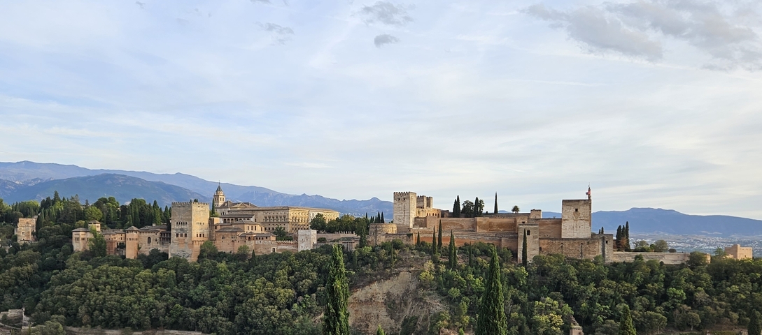 Alhambra palace complex with mountains in the background.