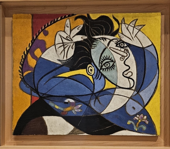 Colorful abstract painting in a wooden frame.