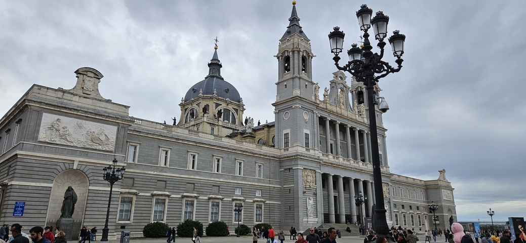 Madrid's royal palace with people around.