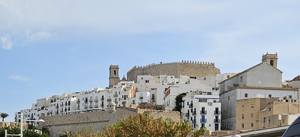 Hilltop village with traditional Mediterranean architecture.