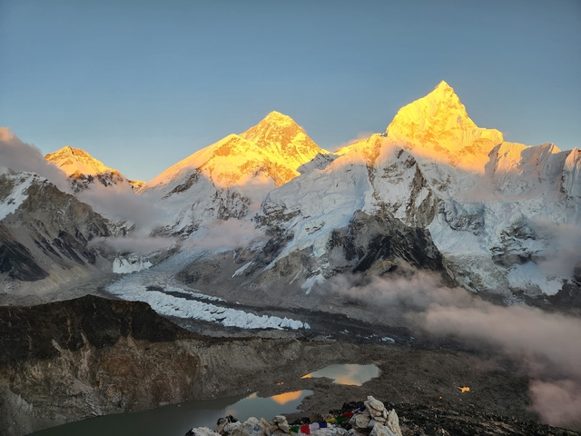 Snowy mountain range with sunrise colors.