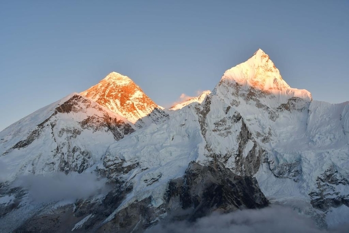 Two snow-capped peaks at sunrise.