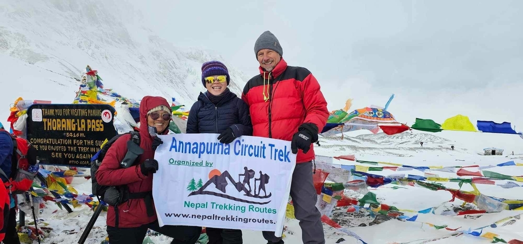 Group of people holding a banner in snowy landscape.