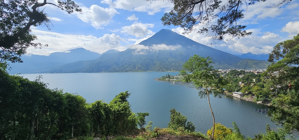 View of a volcanic lake surrounded by greenery.